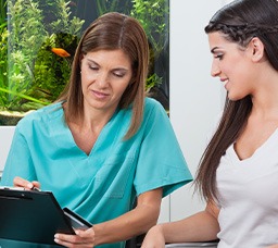 Dental staff helping patient with payment